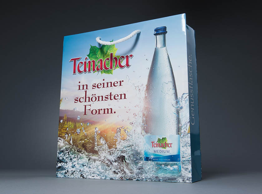 Elaborately printed paper carrier bag with Teinacher Mineralwasser logo