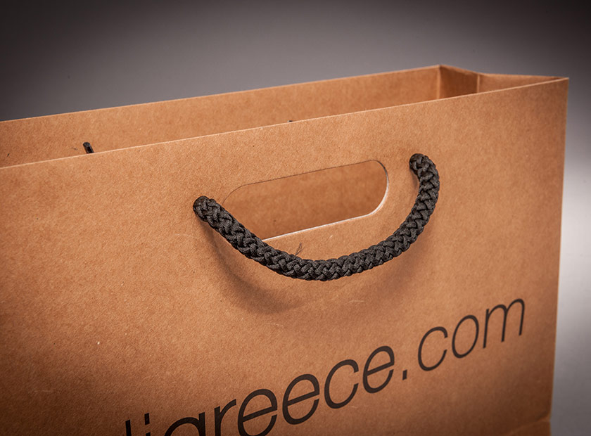 Individually printed paper bag with combined handle/cord