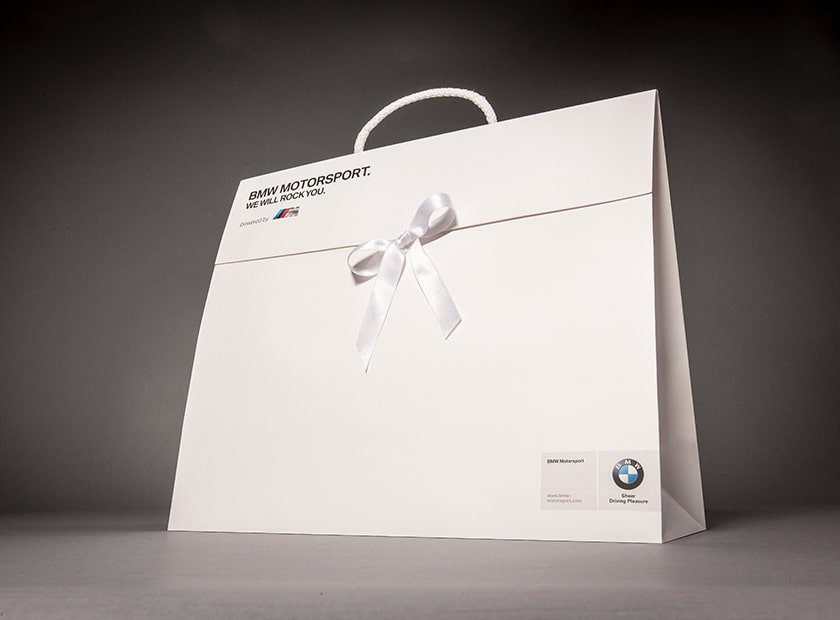 Paper gift bag with cover flap and bow, BMW logo