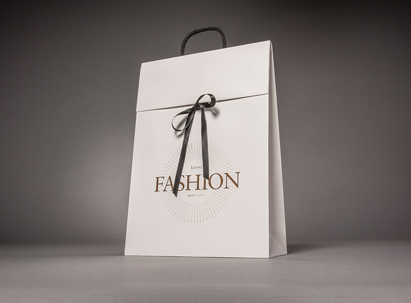 Paper gift bag with cover flap and bow, fashion motif