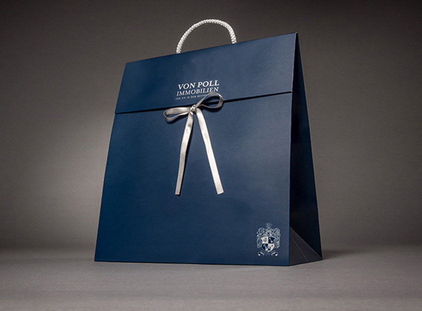 Paper gift bag with cover flap and bow, Von Poll logo