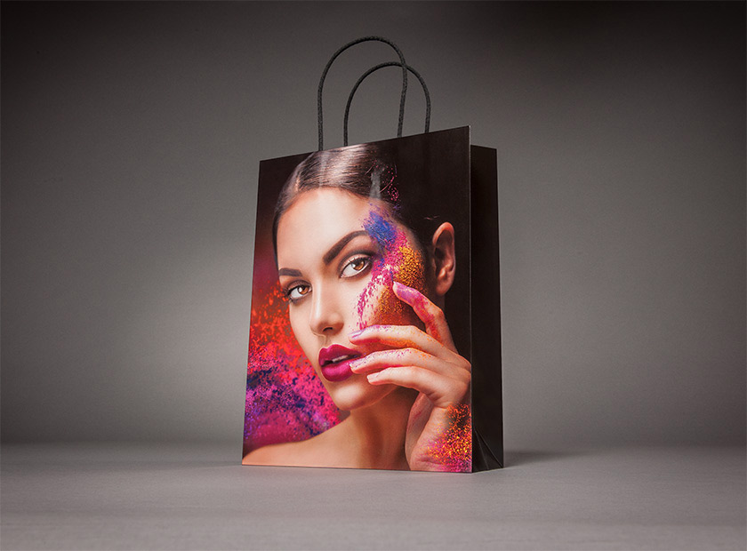 Printed paper bag with paper cord, made-up woman motif